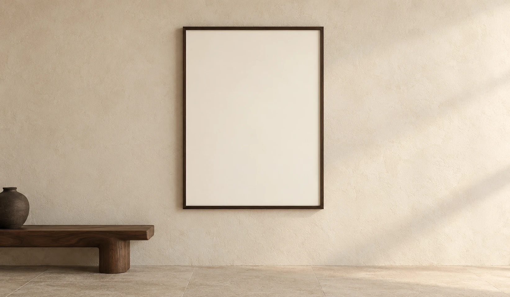 A large walnut-framed artwork on a warm plaster wall beside a sculptural walnut bench